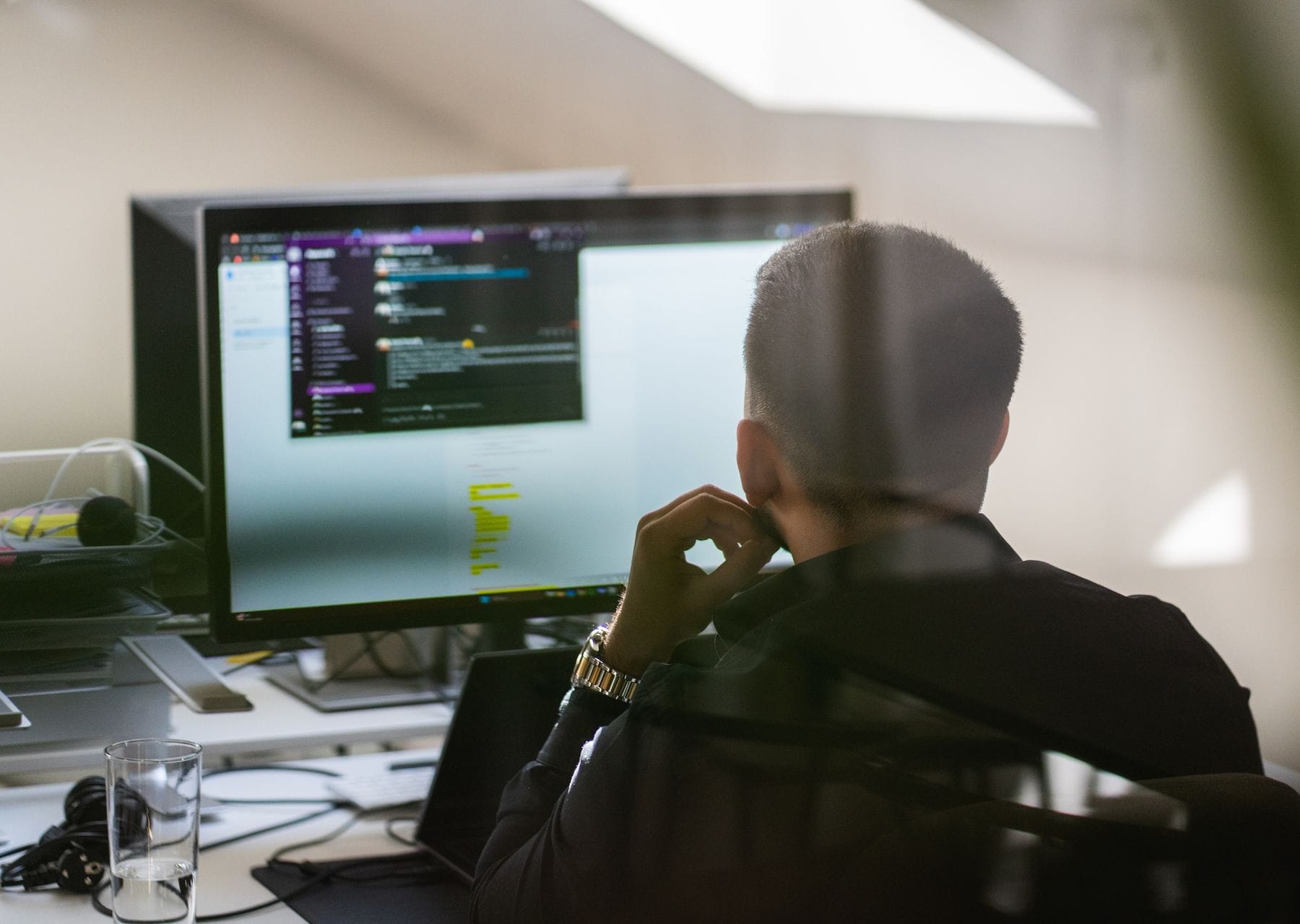 A person looking at code on a computer screen in Pigment's office.